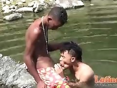 Teen gay swimmer playfully going down in the river