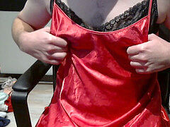 Crosssundresser with marvelous red dress and a lot of panty and boulder-holder